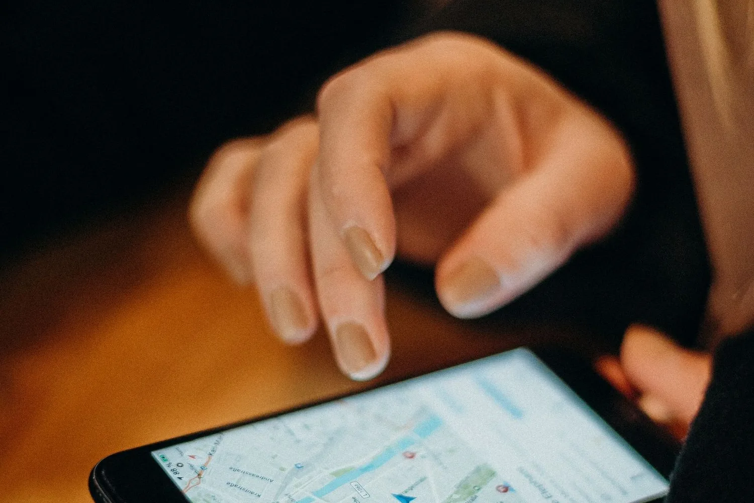 Persona buscant al mapa del mòbil un negoci proper, com fan els clients a Girona