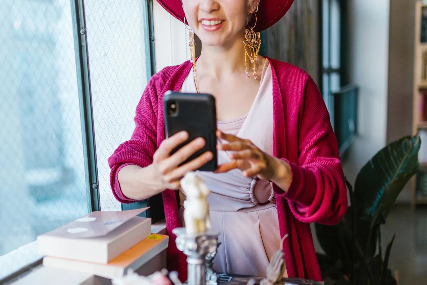 Shop owner photographing her products with the phone in her own shop