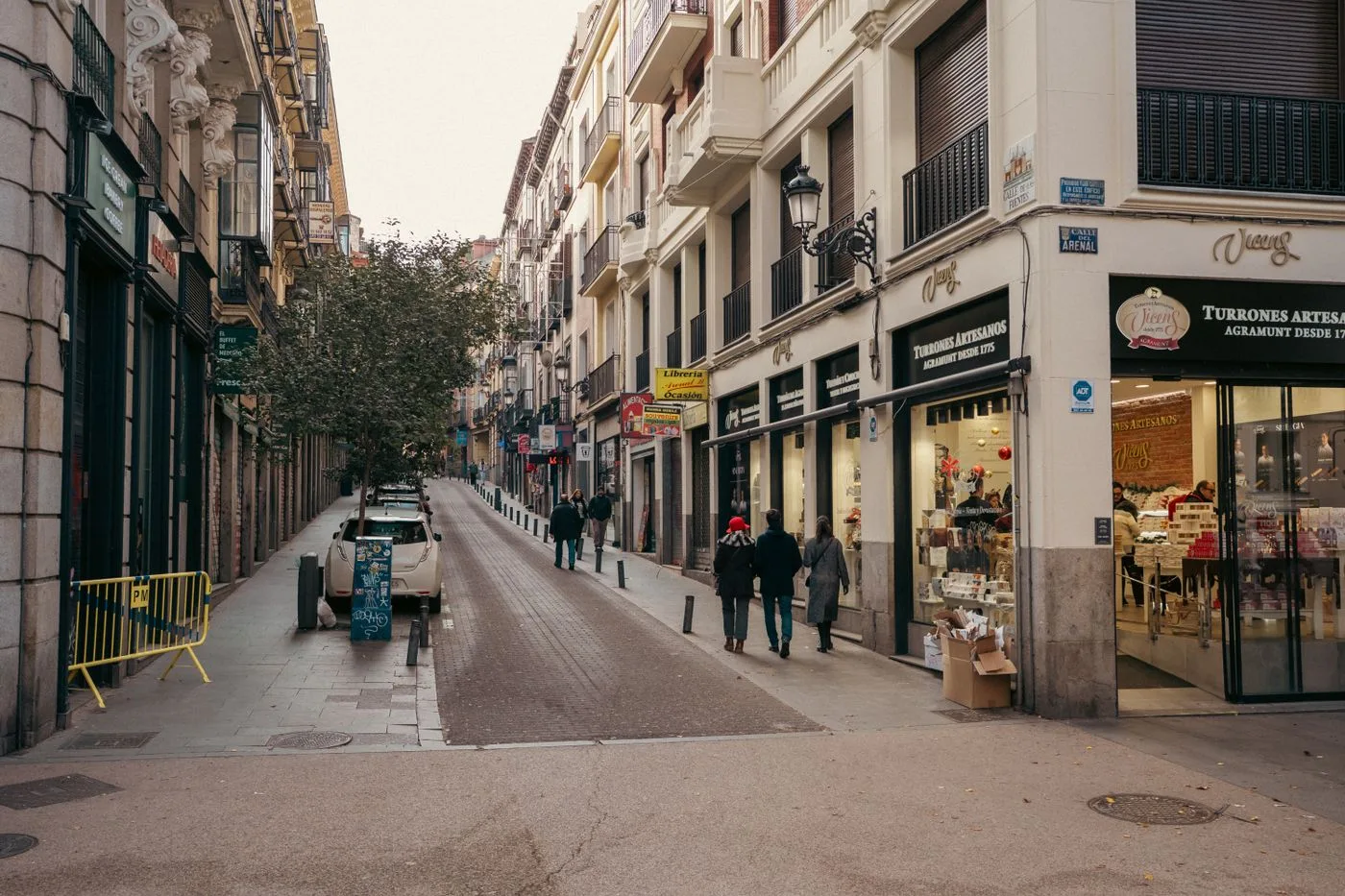 A high street with open shops and people out buying in the afternoon