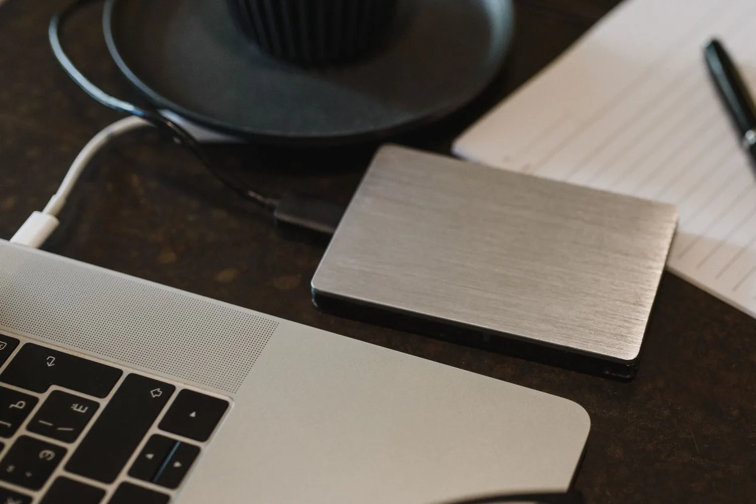 External drive plugged into a laptop to keep a backup of the website