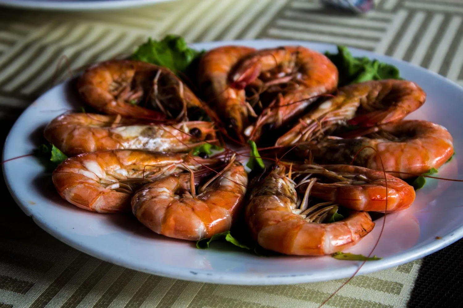 A plate of fresh red prawns just served, the local-product reputation a Palamós business sells on