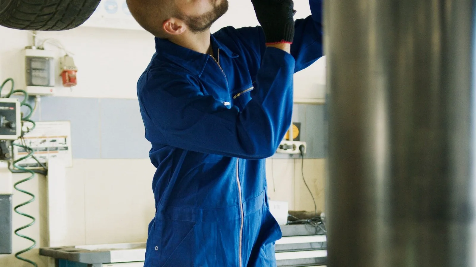 A mechanic servicing a car on a lift, the same preventive care a website needs