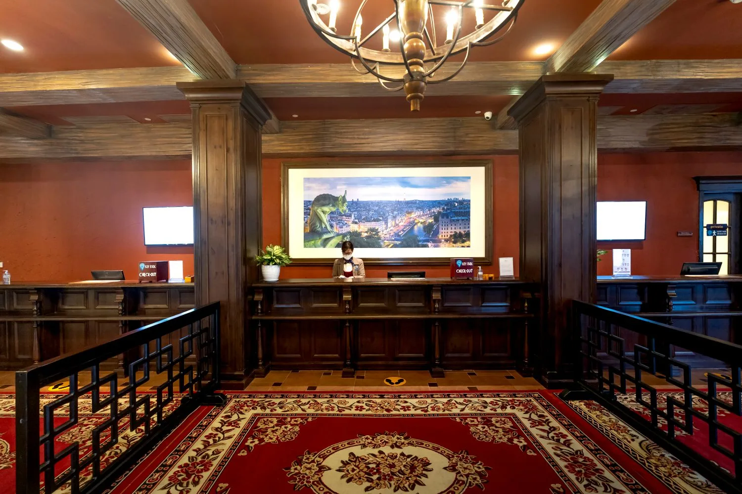 A hotel reception desk with a member of staff; in a tourist town the website works as the first reception desk