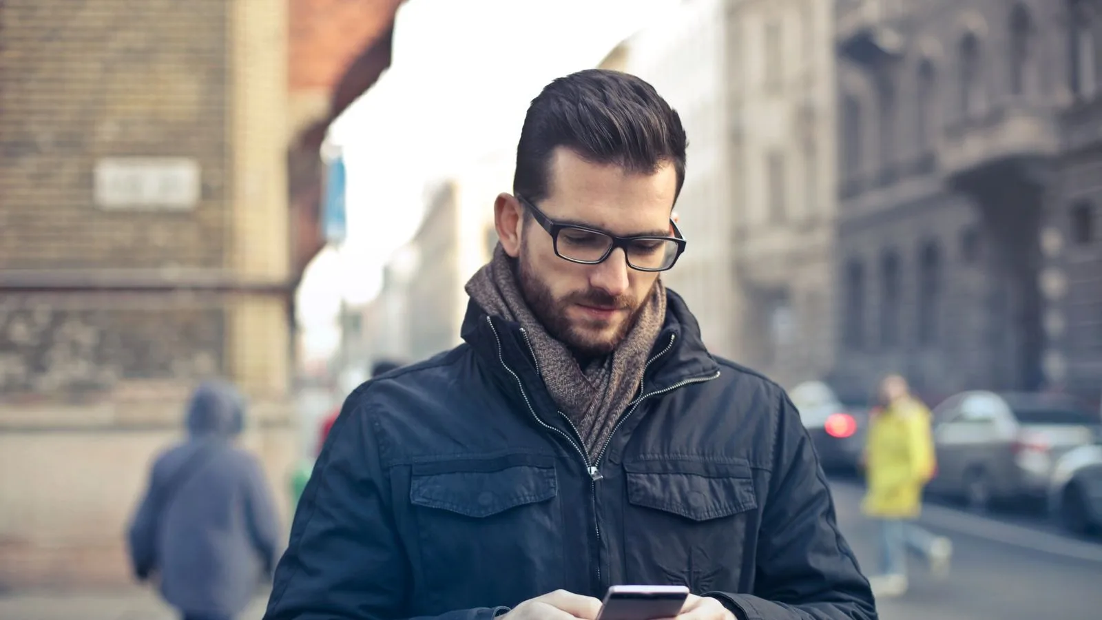 A man on the street searching for a business on his phone and not finding it in Google's results