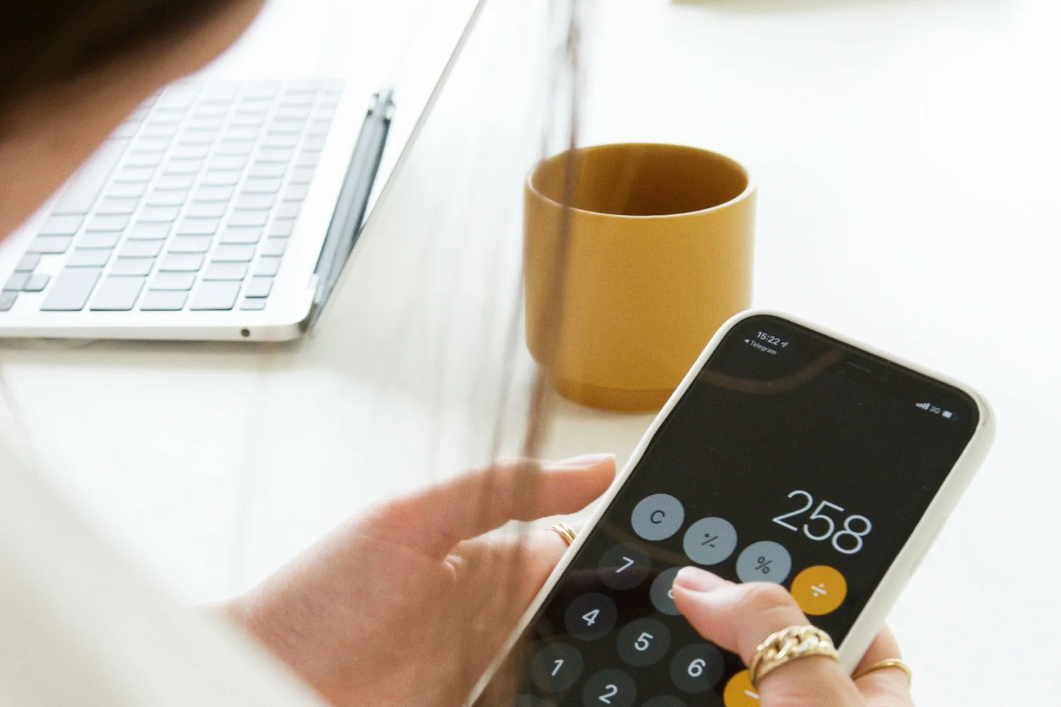 Person running the numbers on a calculator to prepare a website budget