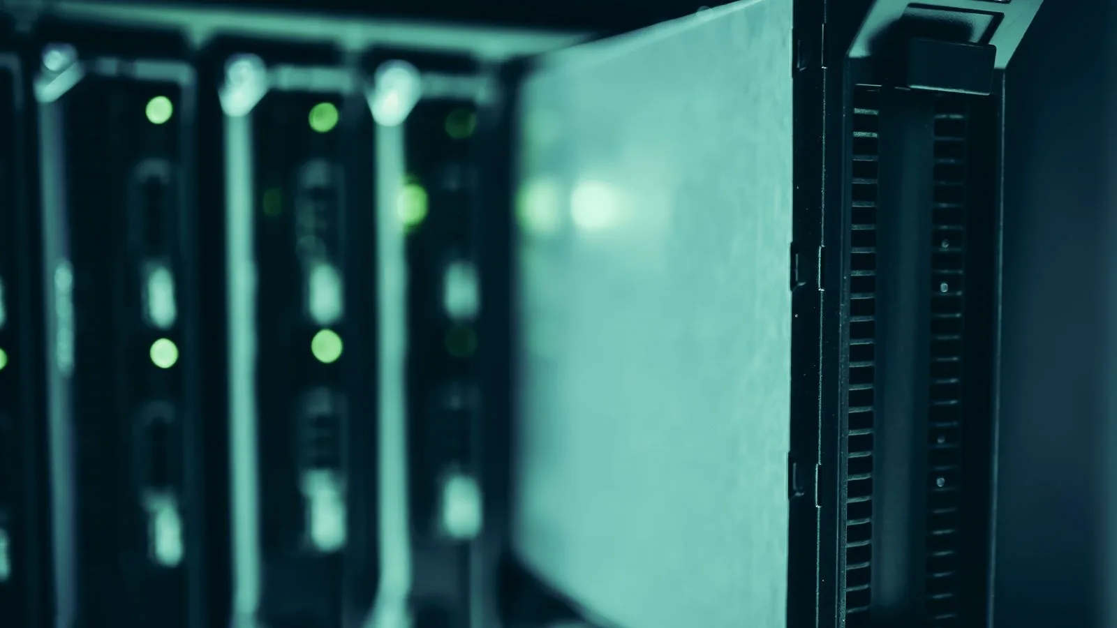 A server half pulled out of its rack in a data centre with the lights on