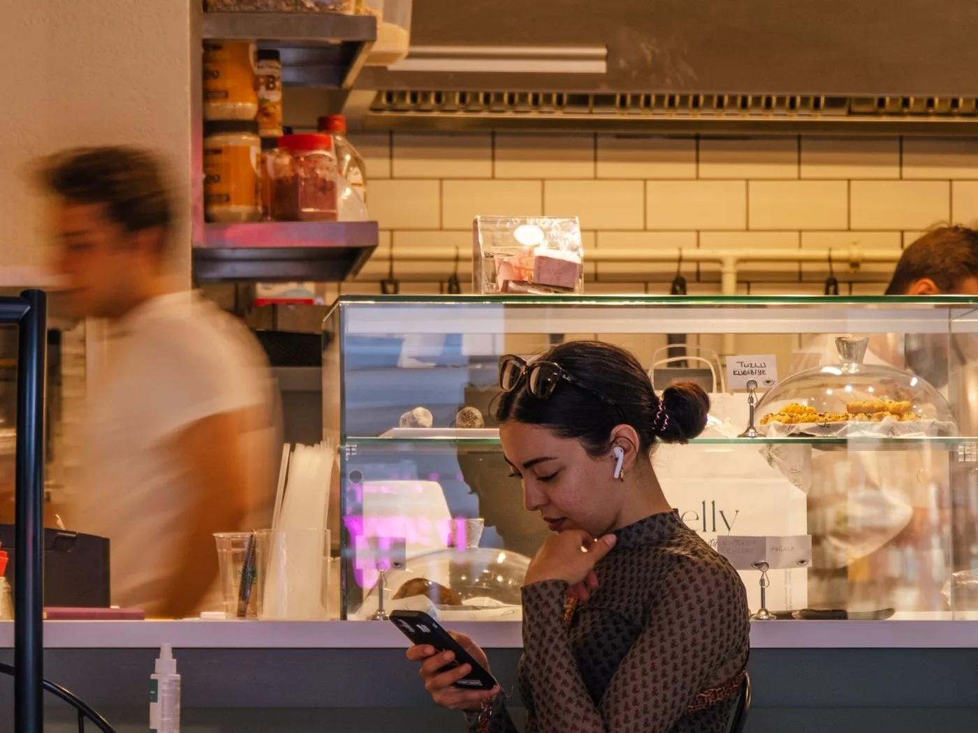 Going through the business messages on the phone next to the bar
