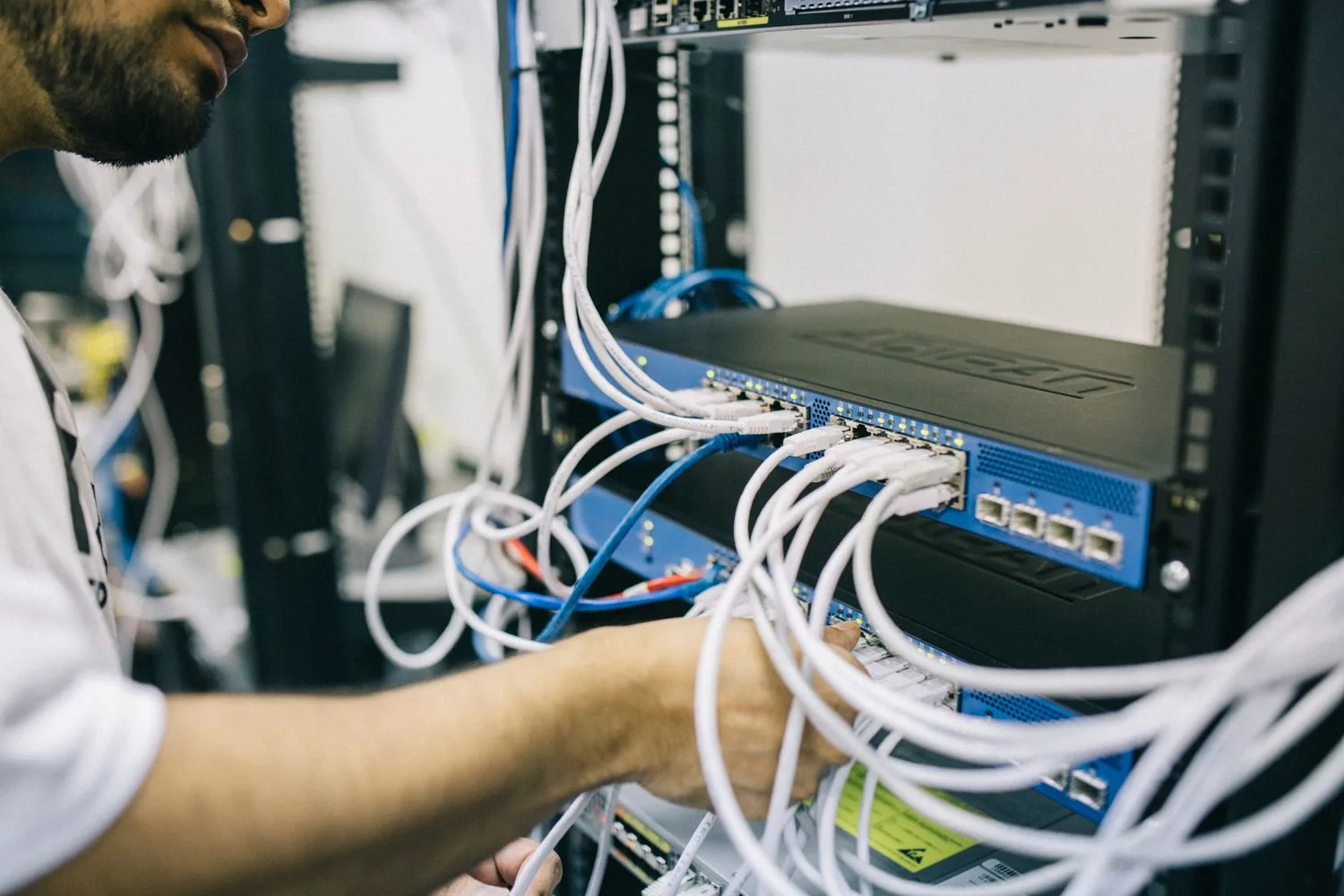 A technician checking the cables of the server hosting the website