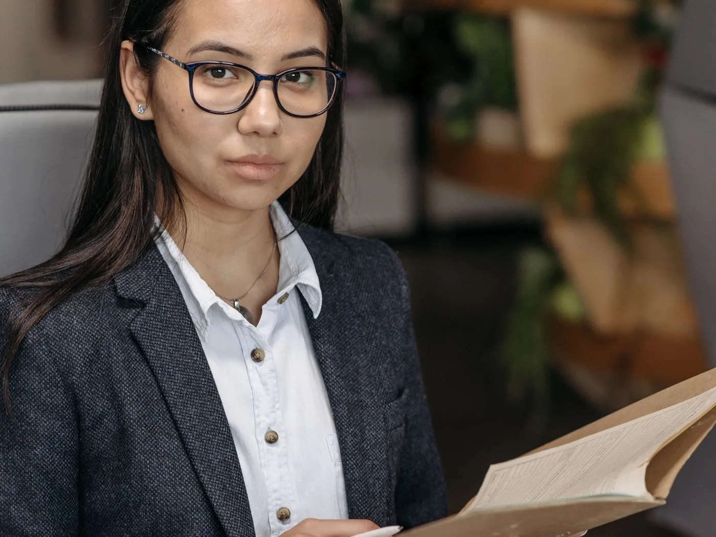 A professional checking the paperwork of a case file at her desk