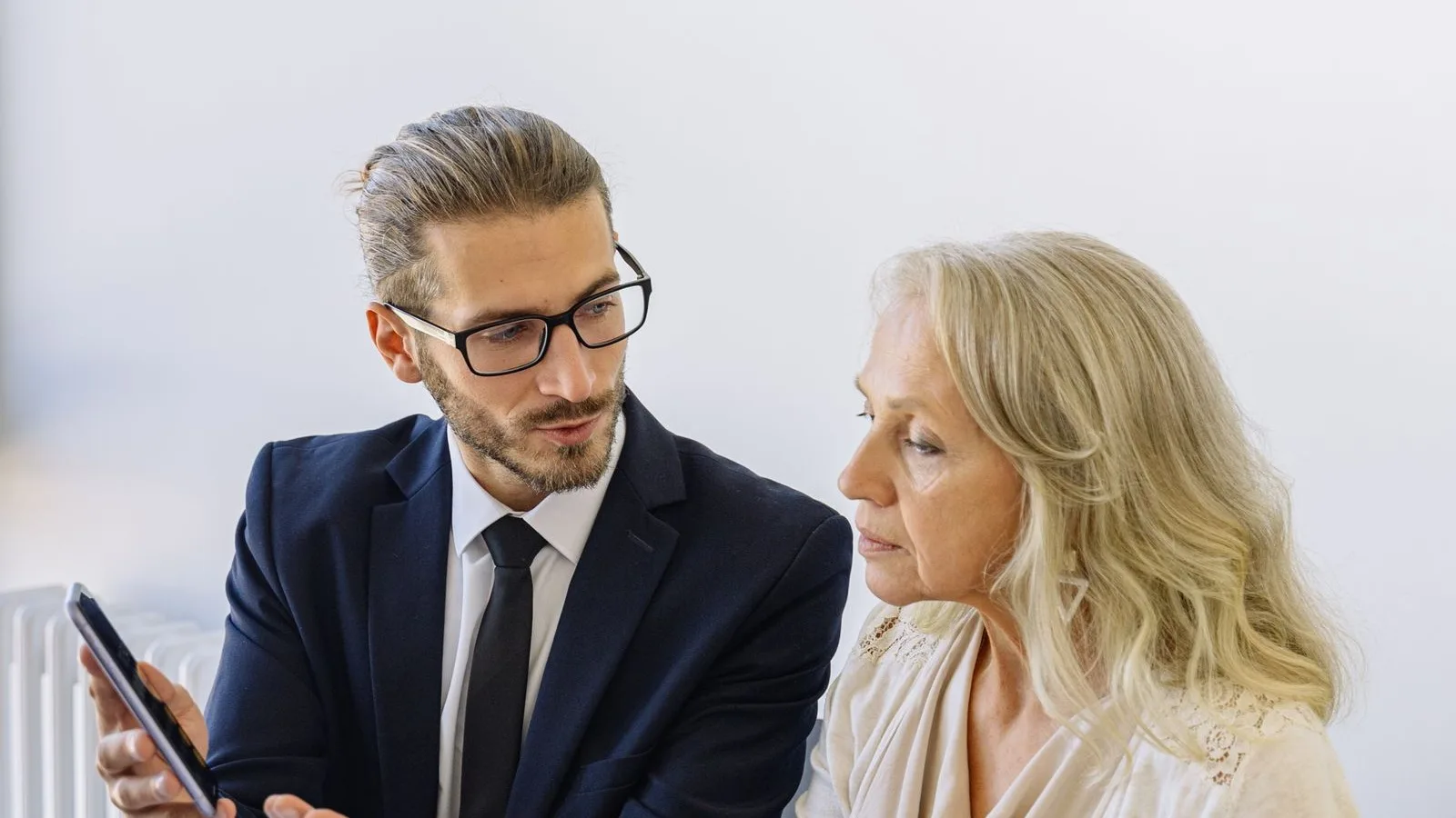 Firm advisor going through a case file with a client, papers spread on the table