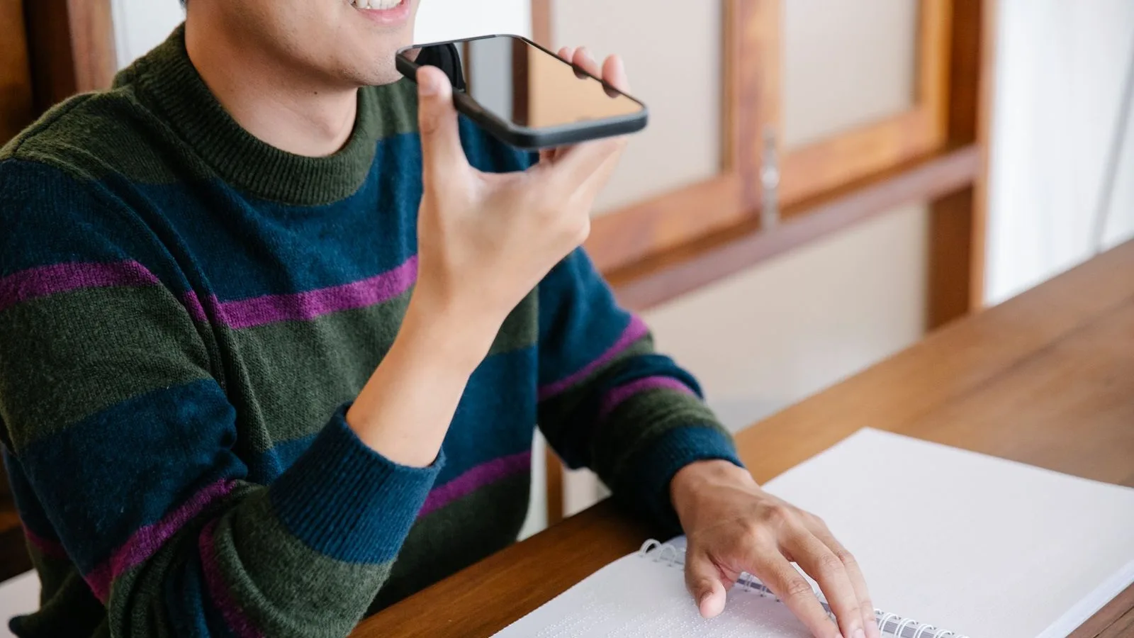 Recording a voice note on the phone to explain out loud what the business does