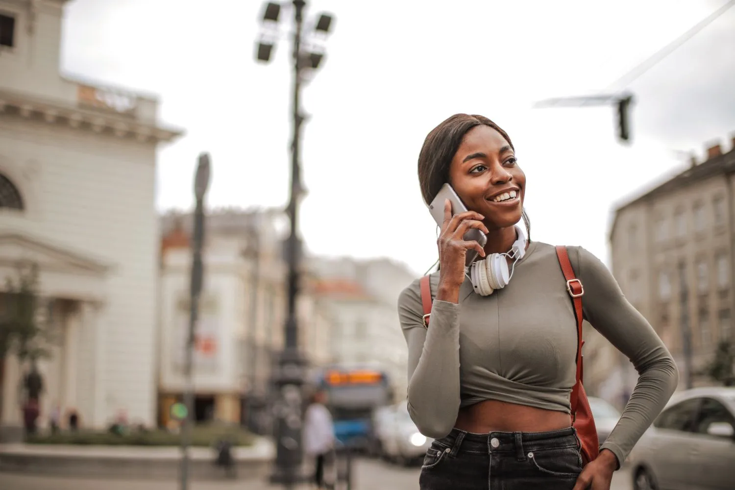 A customer calling on the phone with a smile, choosing the way of getting in touch that feels right